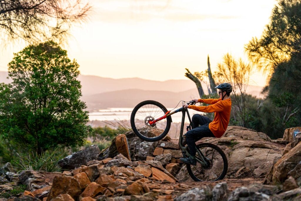 A bicycle leaning against a rock wall