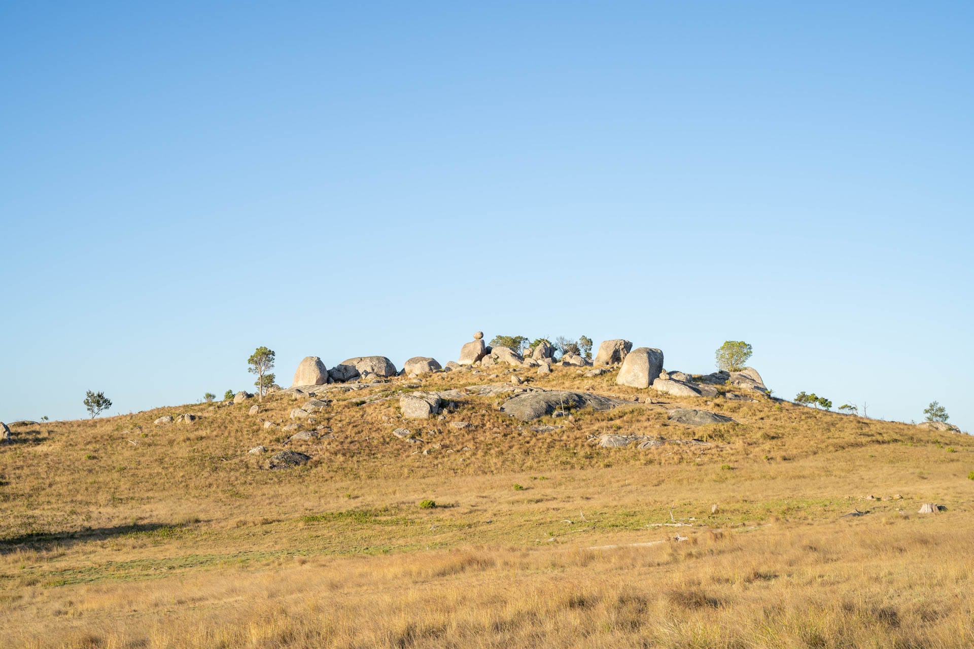 A Weekend in Tenterfield: Where to Stay, Adventure, and Eat, constance allan, boulder outcrop in a paddock