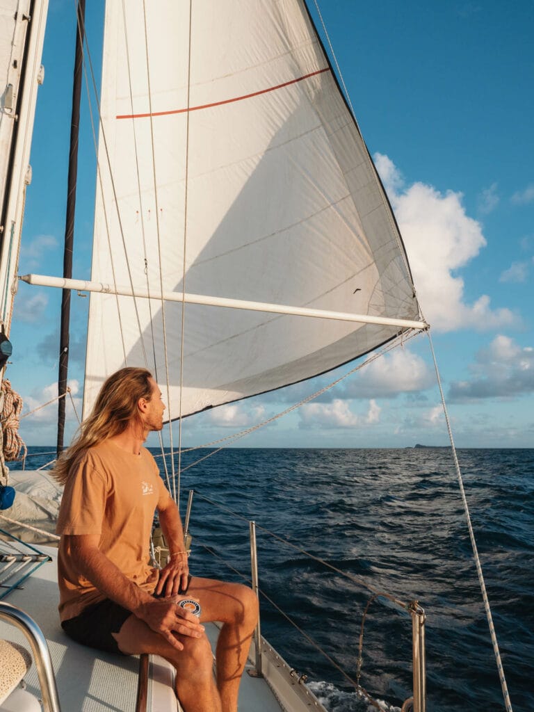 The Percy Isles: A Guide to Visiting Middle Percy Island, Lily and Hayden Greener, man sailing, ocean