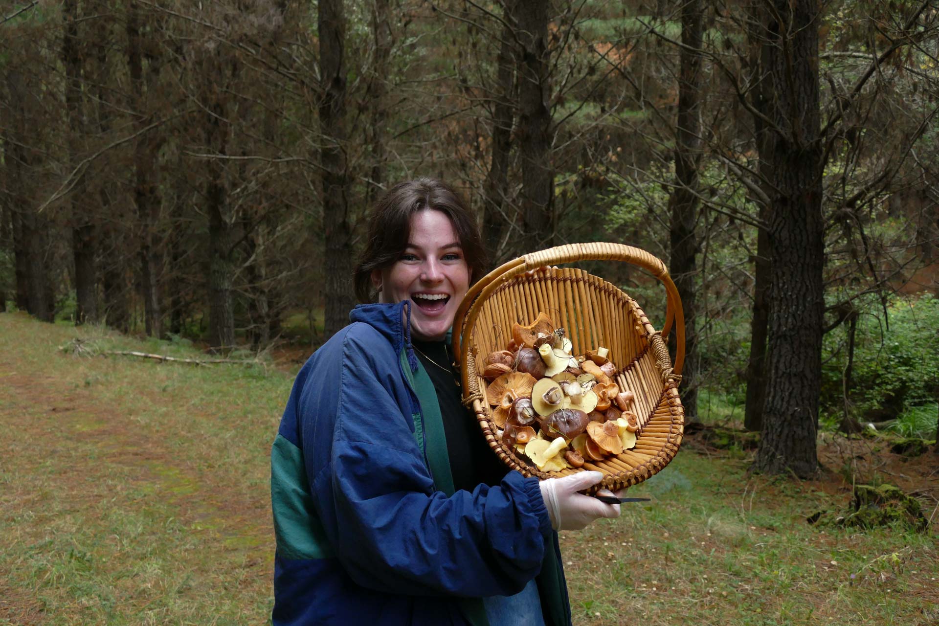 Mushroom Hunting – Foraging for Fungi in Orange With The Market Cat, Kate Scott, person smiling and holding up a basket of foraged mushrooms
