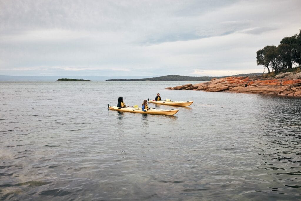 Paddle the Freycinet Peninsula – A Guide to Kayaking This Spectacular Tassie Coastline, Remi Chauvin, ocean, coast, kayak, couple, friends