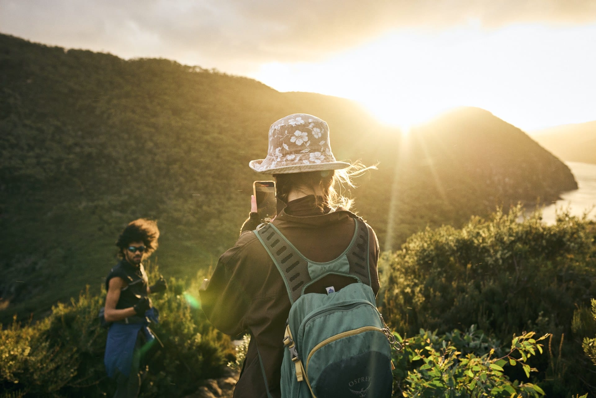 Cape Hauy – A Guide to Hiking This Jaw-Dropping Tassie Coastline, Remi Chauvin, hiking, Tasmania, sunlight, friends, phone, photo, couple