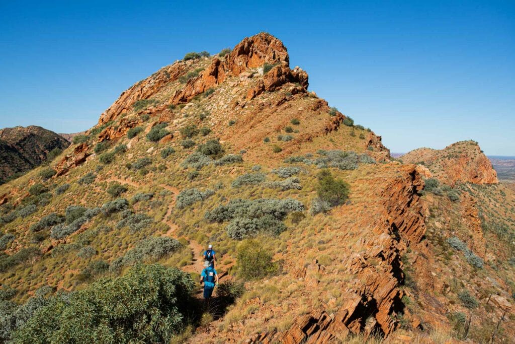 Did You Know You Can Trail Run in the Red Centre?, Jayden O'neill, trail runners on the west mac monster ultra run, running up a rocky hill