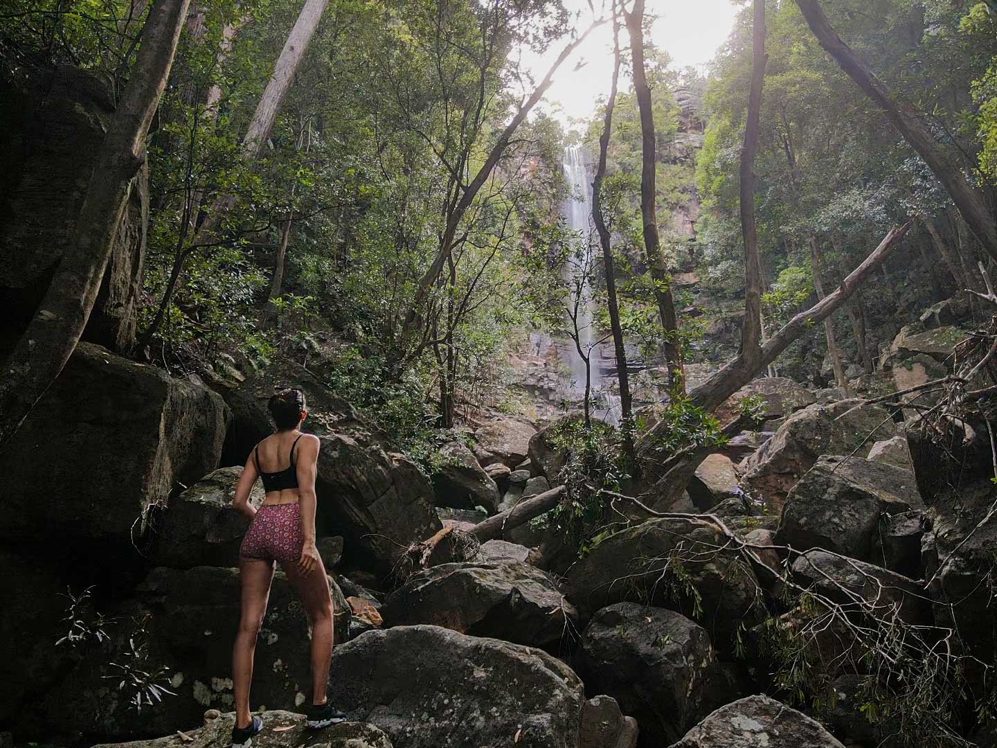 Wollongong Weekend Getaway Guide, Sharmali K, kelly's falls track, stanwell tops, lady standing in rainforest in front of waterfall