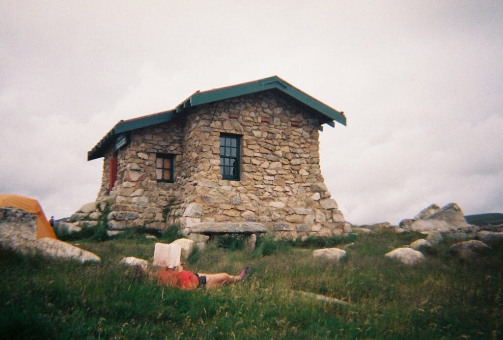 The Healing Power of Nature is Closer to Home Than I Realised, Ruby Bisson, woman, mountain, hut, cloud, reading