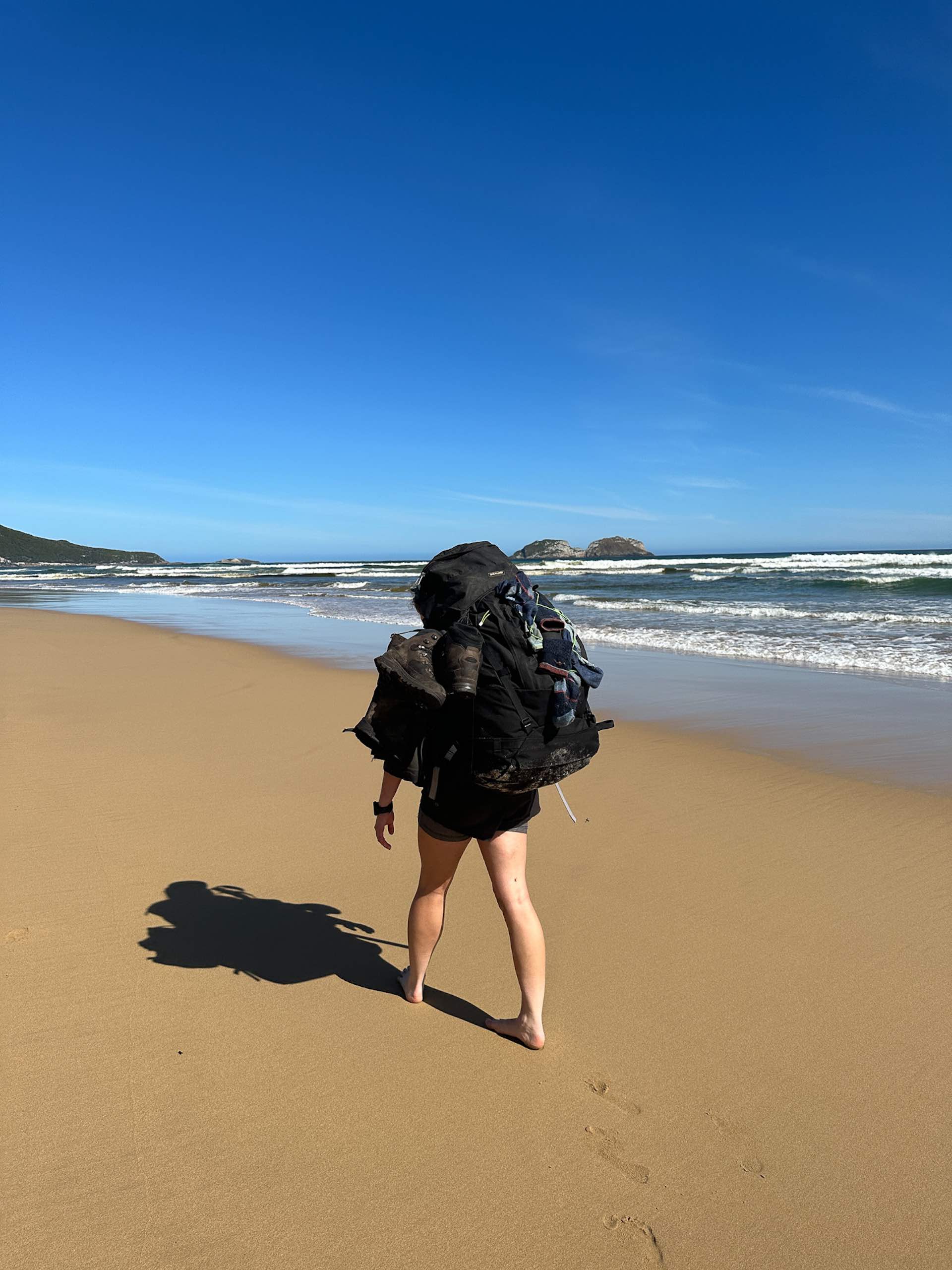South Coast Track – 5 Days Hiking in Tassie’s Remote Southwest National Park, Alissa Ward, Tasmania, sand hiking, hiker on sand, hiker wearing pack,