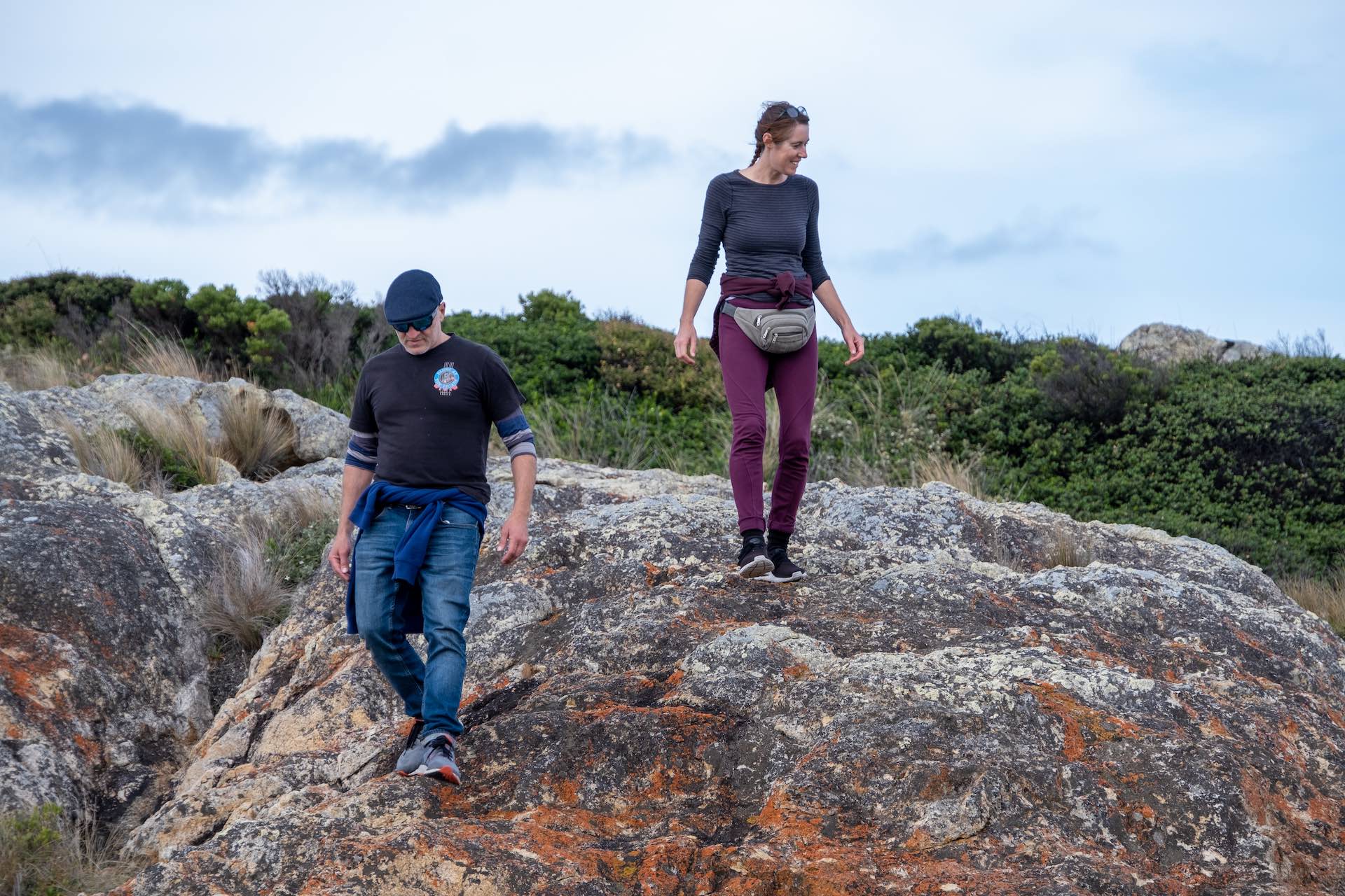 Hiking A Remote Tasmanian Paradise - Ansons Bay to Eddystone Point, Lisa Ikin, Tasmania, male and female hiker, red rocks,