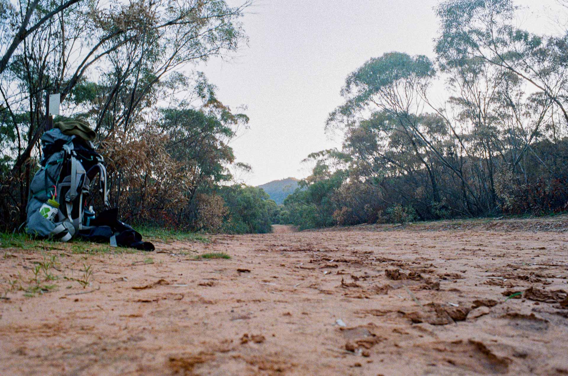 Longing for Loops at Mount Remarkable, a Multi-Day Hike, south australia, multi-day hike, SA, south australia hiking, backpack on side of the road with mountain in the distance 