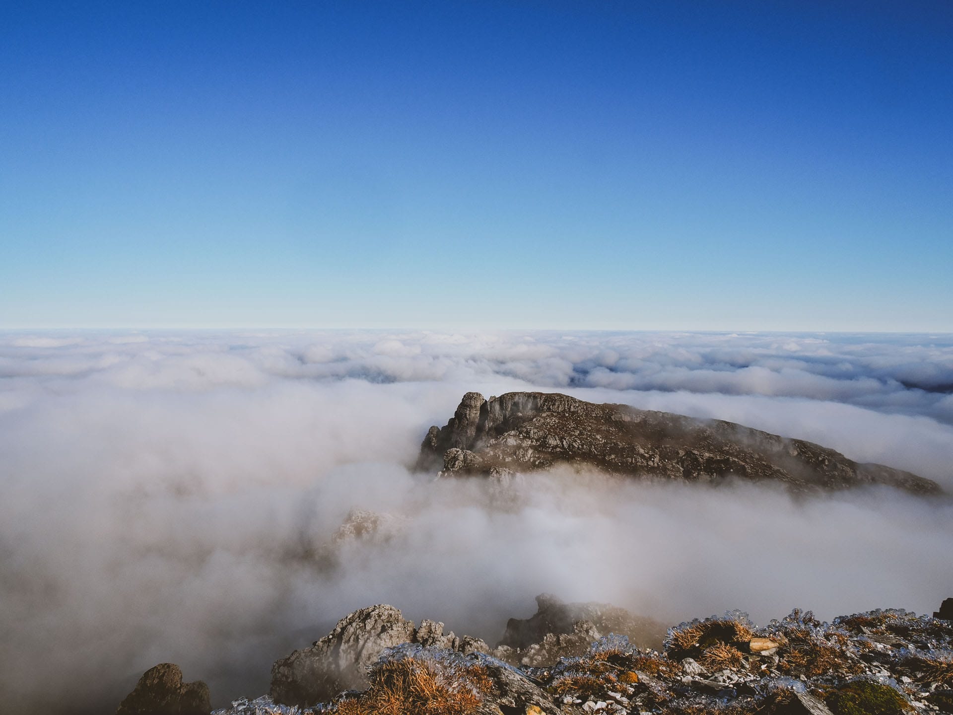 Why I Calculated the Opportunity Cost of Hiking, mountain, inversion clouds, rocky mountain top peering through layer of clouds