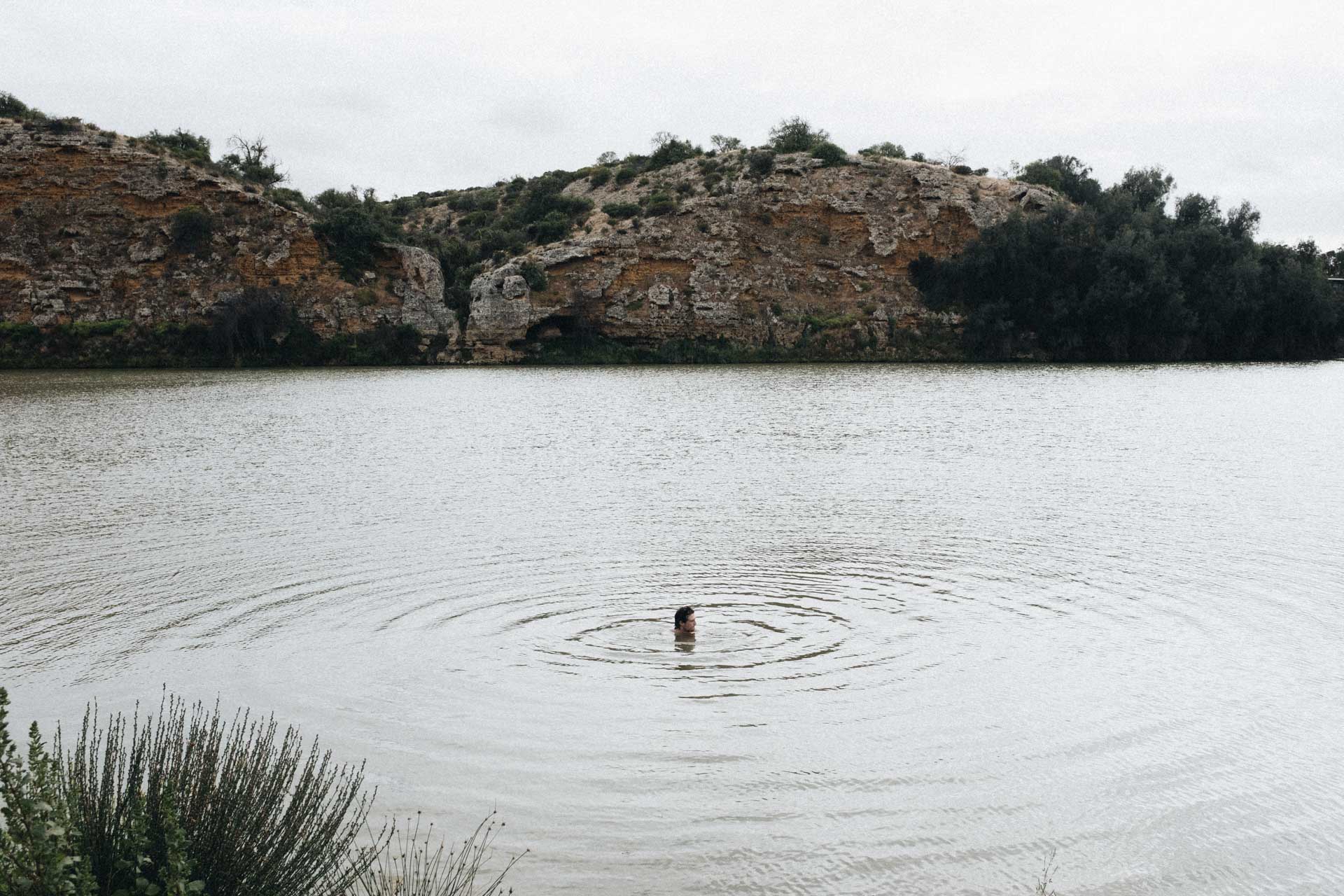 I Went Back To Basics On My Murray River Bikepacking Trip – Here’s What I Learnt, bikepacking, cyclist taking a swim break in a lake