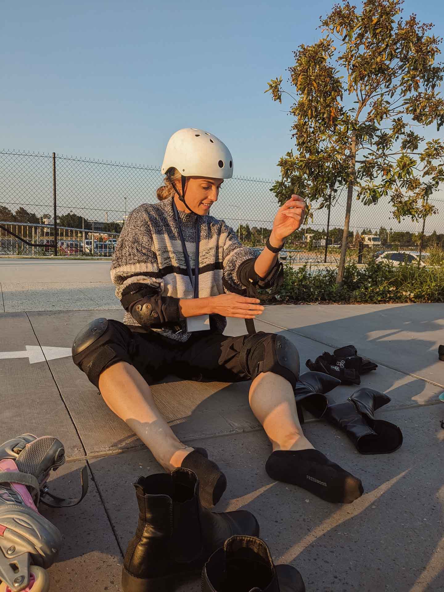 A 4am Rollerblading Commute to Work, rollerblading, microadventure, brisbane, a lady taking shoes off and putting on skates and protective gear outside