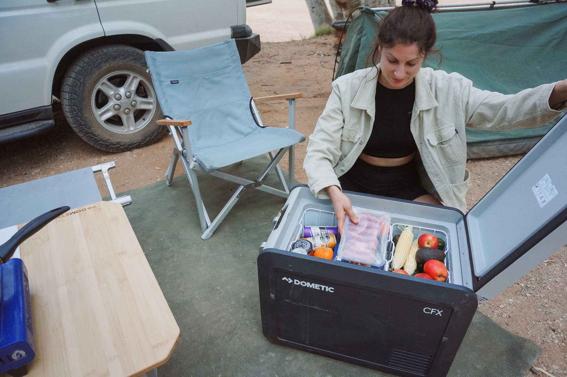 How a Dometic Fridge/Freezer Will Take Your Camping Set Up to the Next Level, gear, dometic, camping, camp cooking, lady going through dometic fridge while camping