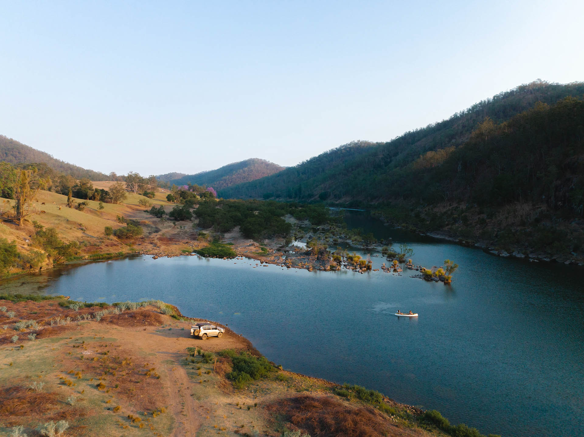 I Never Thought I’d Become a 4WD Guy, kaon, sponsored, drone shot of a 4wd on the banks of a river while a family canoe