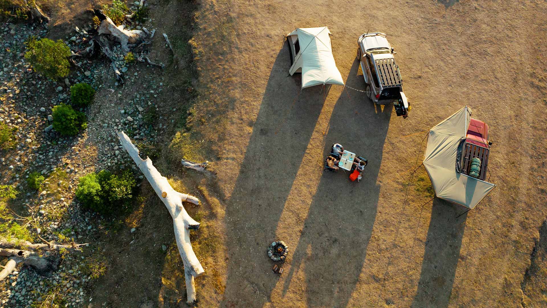 I Never Thought I’d Become a 4WD Guy, kaon, sponsored, aerial drone shot of a family 4wd camping with a fallen tree on the left