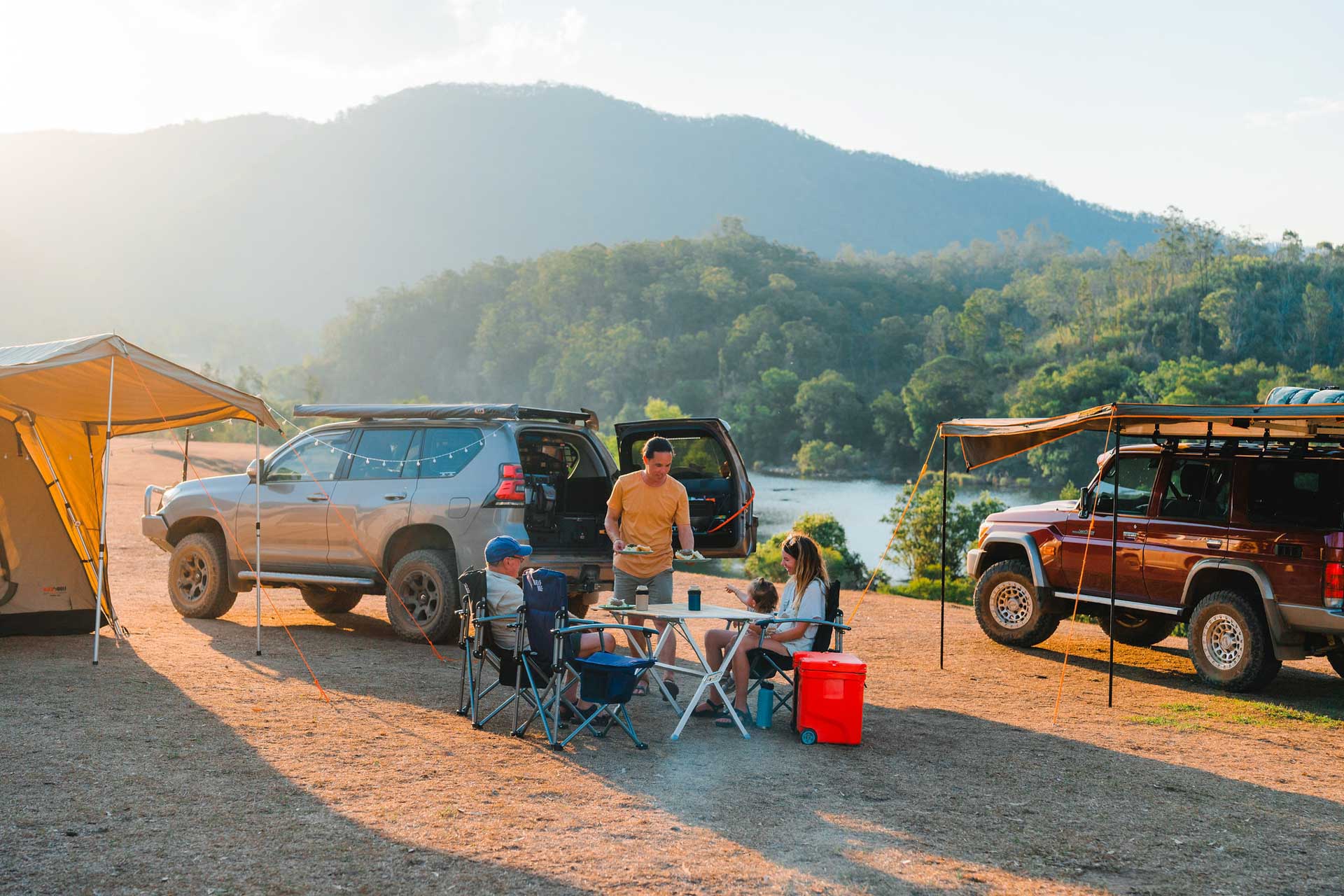 I Never Thought I’d Become a 4WD Guy, kaon, sponsored, family camping along a river with two 4wd setups behind them