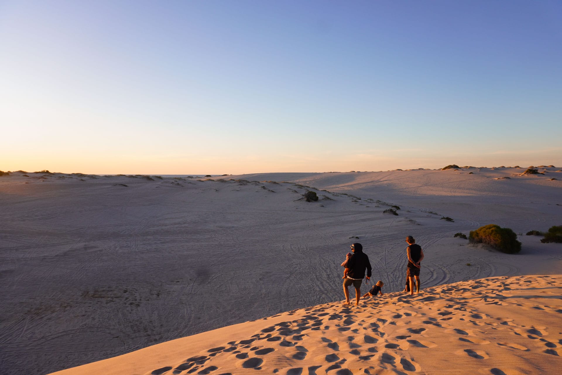 50 Lessons From a Road Trip Across Australia, journal, camping, roadtrip, family walking across sand dunes at sunset