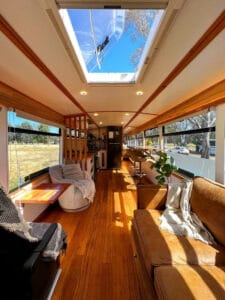 Got a Lazy $160k? Drive Your Savings Away in This Bus, news, skoolie, bus conversion, alternative living, interior of scania 2000 that's been converted into a home showing the living area with dometic skylight