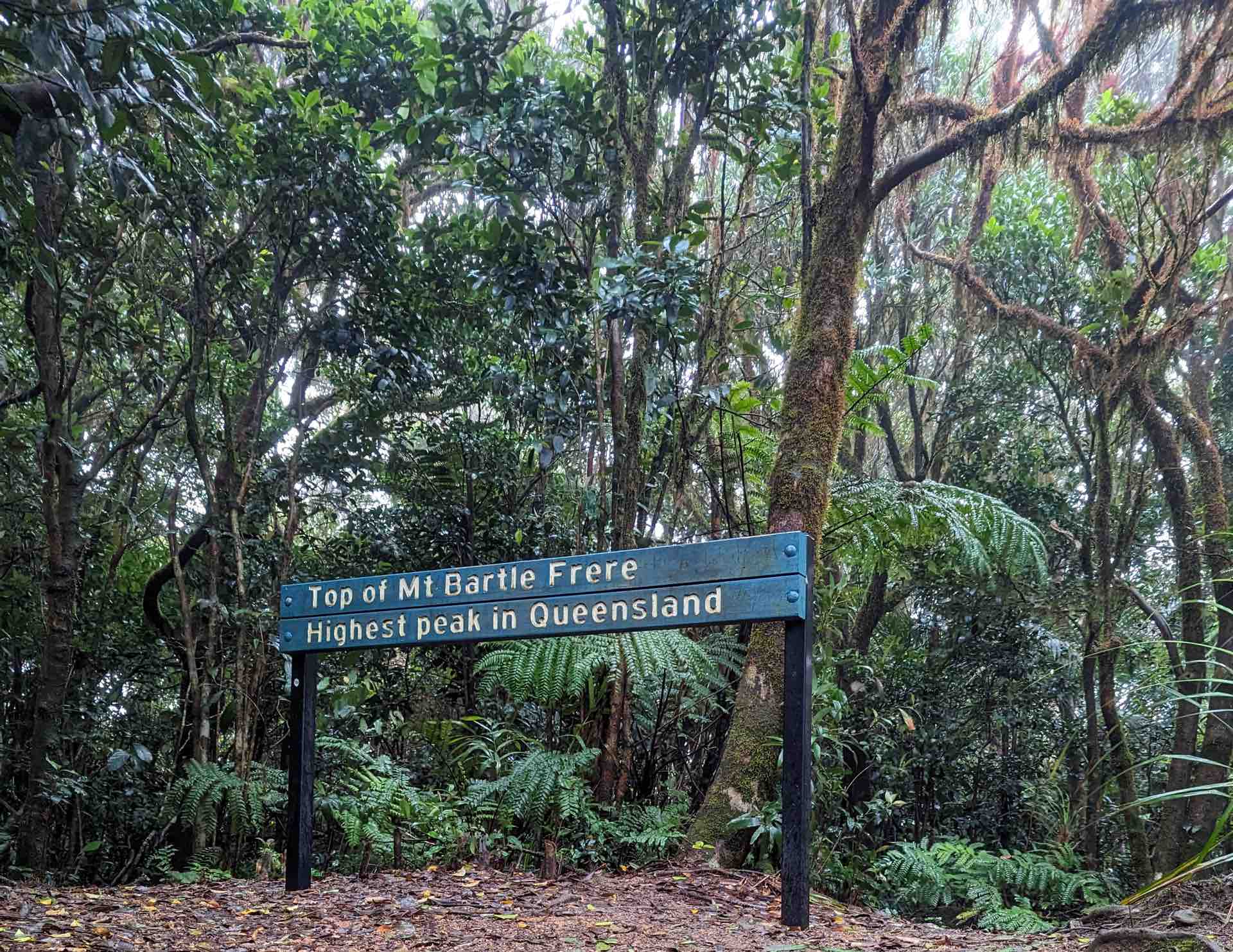 This Guy is Summiting the Highest Point in All 16 of Australia's States & Territories, william crompton, hiking, australian mountains, sign at the top of queensland