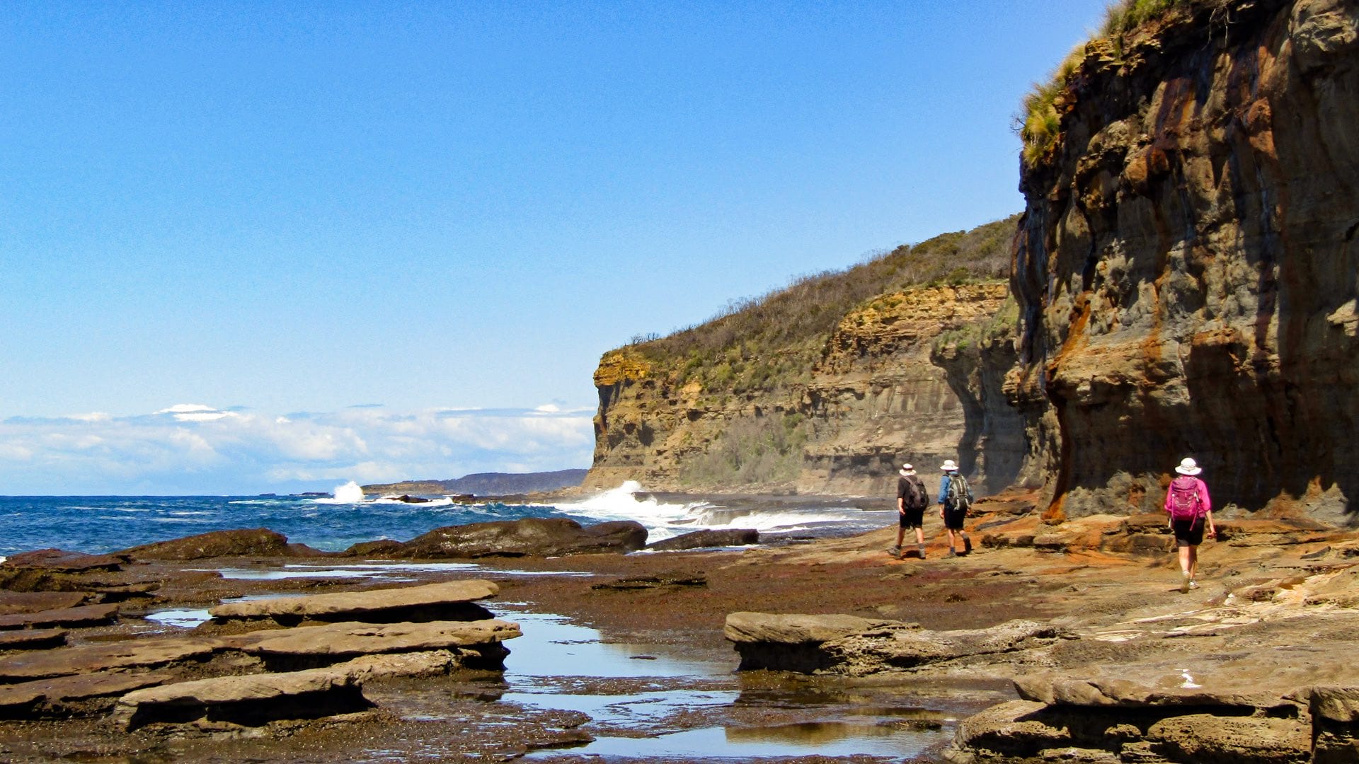 How My Wife & I Spent 20 Years Creating the Great South Coast Walk in NSW, Photo by David Briese, south coast NSW, beach hiking, multi-day hike, coastline, hikers along a rocky platform on the great south coast walk