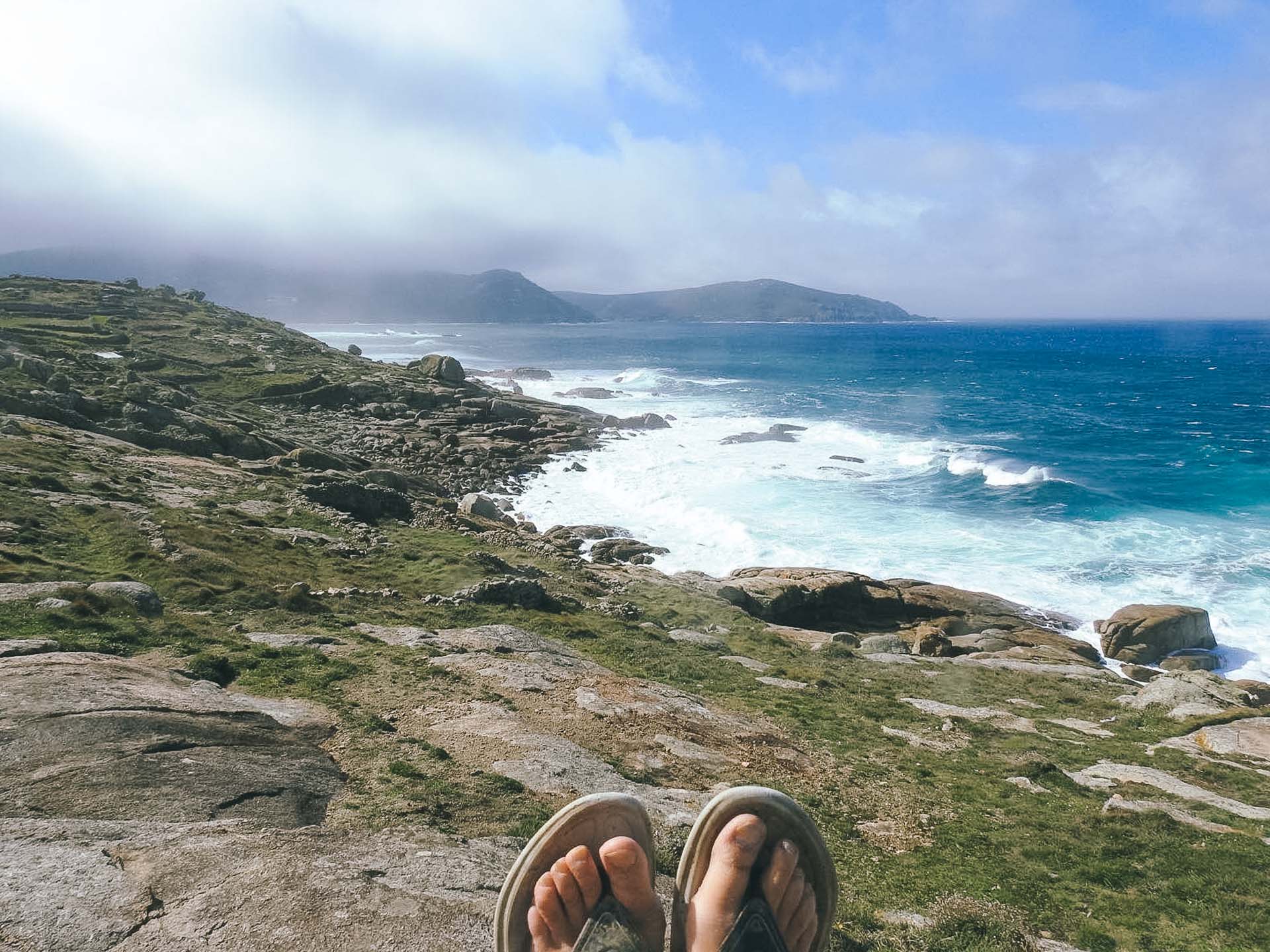 Paralyzed From the Neck Down to Cycling the Camino de Santiago: Meet the Unstoppable Cate Green, Photos by Cate Green, Q&A, MS, cycling, bike, bikepacking, camino de santiago, pilgrimage, sitting on beach along camino de santiago