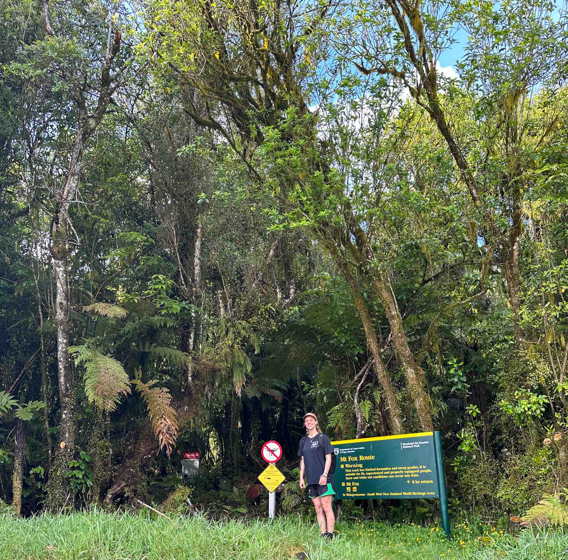 Mount Fox Route – New Zealand’s Fox Glacier’s Greatest Scramble, Photo by Connor Fisher, nz hikes, fox glacier, day hike, Hiker posing at the trailhead of the mount fox route in new zealand