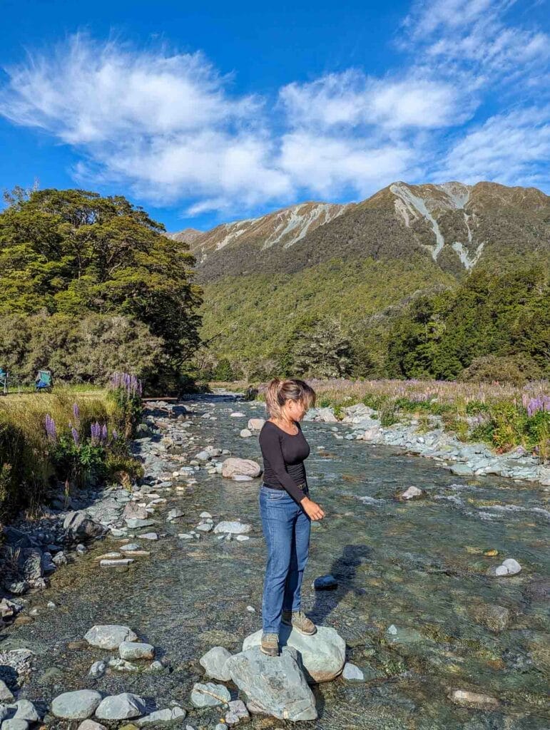 How I Got Over the Post-Holiday Blues, Photo by Sharona Lin, inspiration, journal, new zealand, woman with black blouse and jeans posing in front of mountains