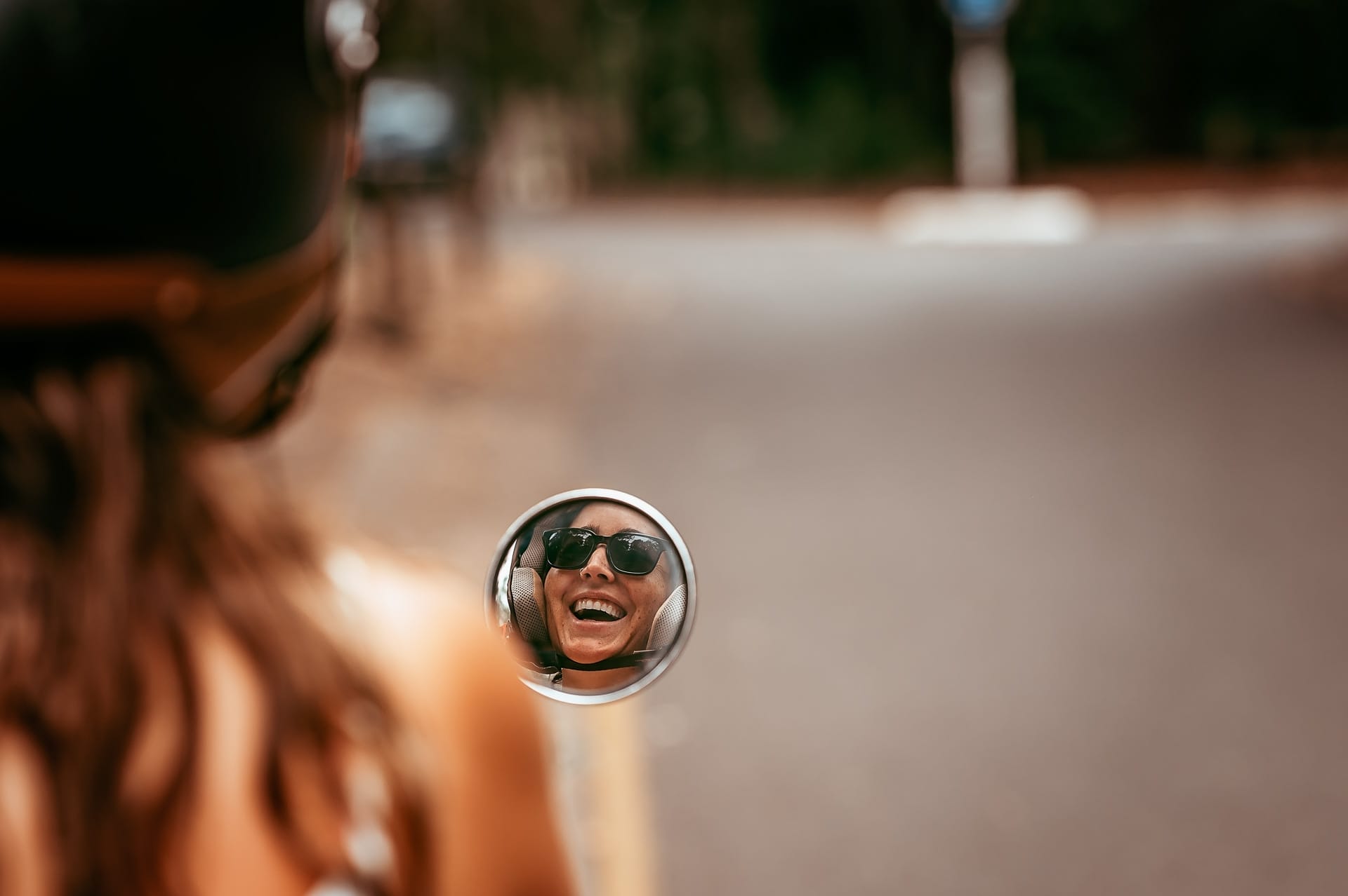 This Surfer Turned Her Love of the Ocean into a Conservation Mission, Photo by Bec Walker, noosa heads, sunshine coast, conservation, ocean conservation, surfing, interview, lucia santiago smiling in the reflection of her scooter
