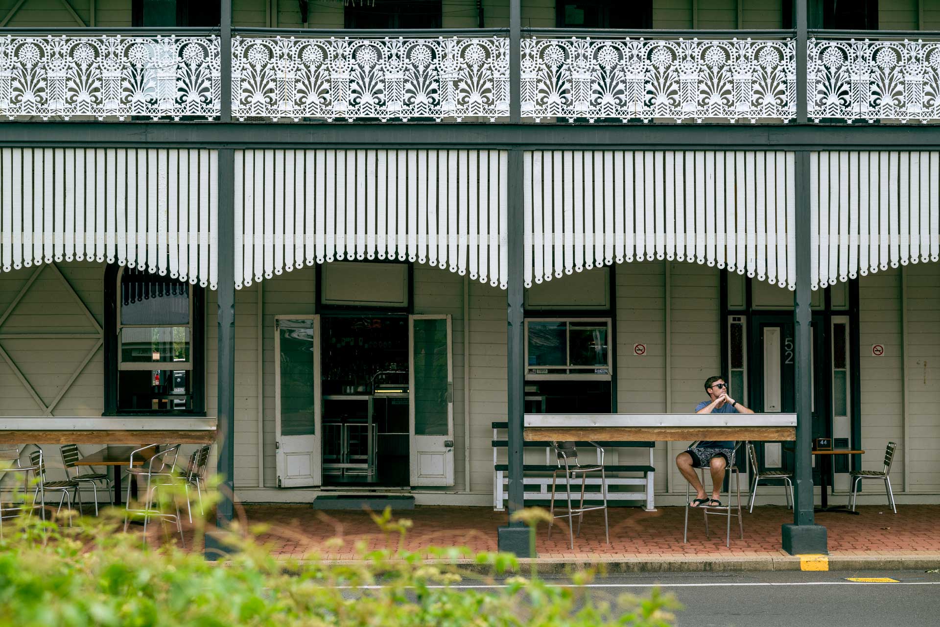 6 Queensland Country Pubs, Bars, & Distilleries with Adventures Nearby, Photo by Rian Cope, queensland, southern queensland country, sponsored, man sitting on outdoor table at lockyer valley hotel