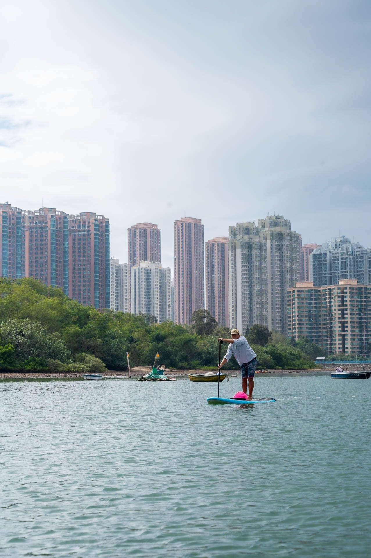 Mountains, Islands, and Deserted Beaches: Travel Hong Kong Like an Explorer , Photo by Cam Bostock, hong kong, international, travel guide, man stand up paddle boarding in sham chung