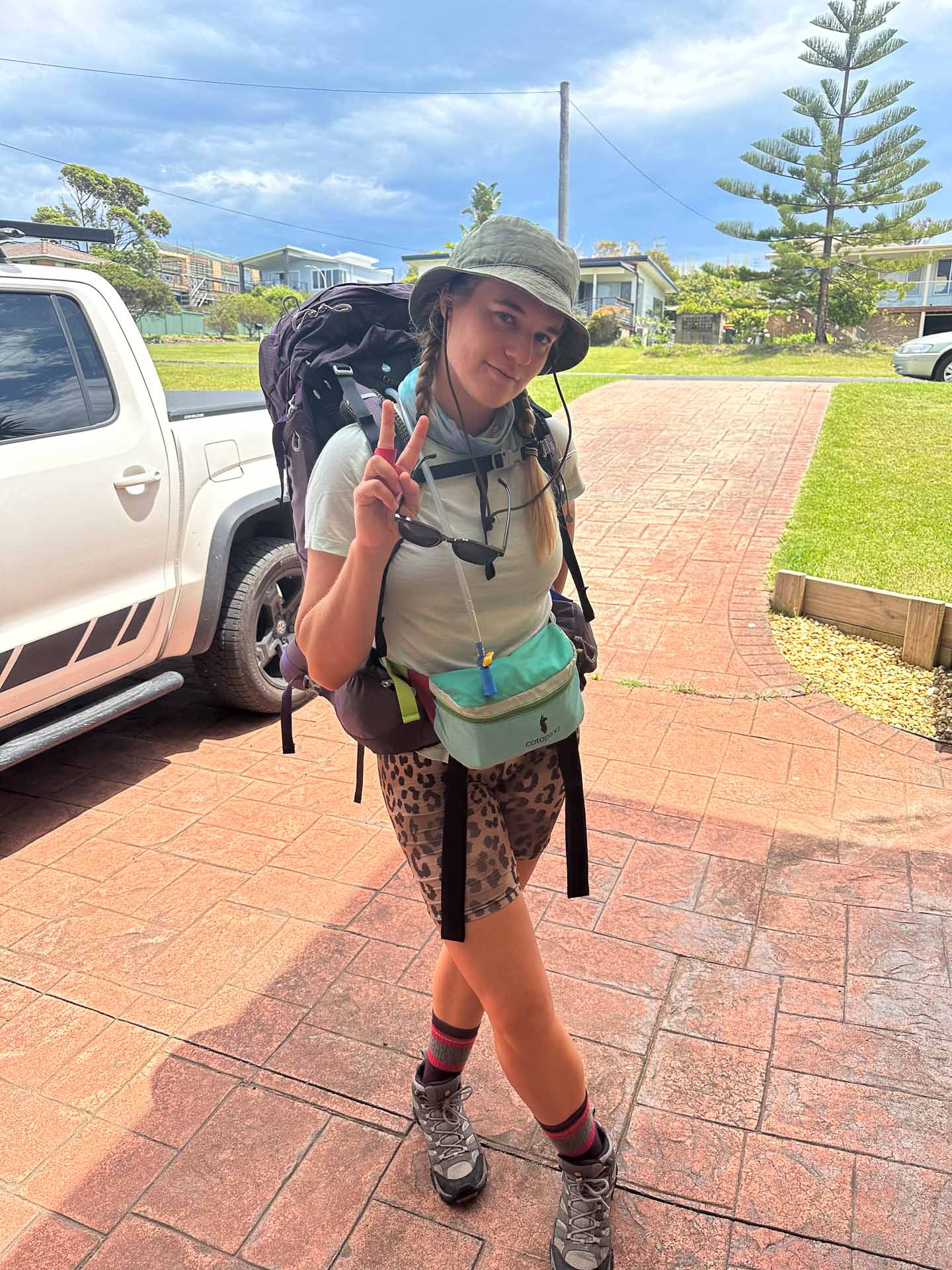 How to Plan Your First Off-Track Solo Hike, Photo by Eva Davis-Boermans, solo hiking, hiking tips, hiking advice, selfie, eva davis-boermans holding up a peace sign in the driveway