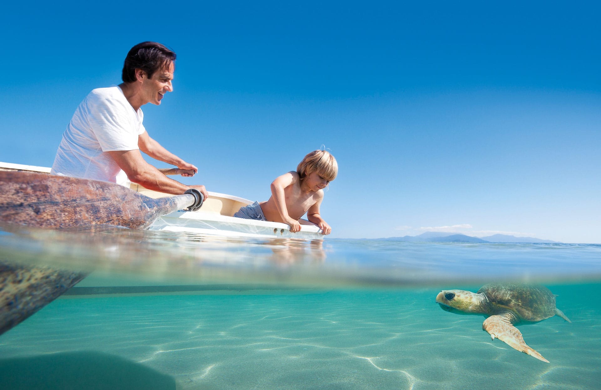 What It's Like to Compete in an MTB Event (& Why You Should Enter the UCI Masters MTB Championships in Cairns), Photo from TTNQ, Father and son kayaking with turtle on the Great Barrier Reef