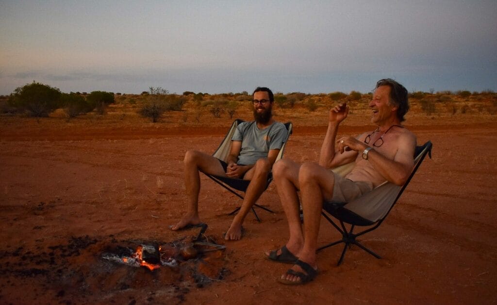 An Ode to The Golden Hour Campfire Chat, Eva Davis-Boermans, campfire, camping, desert, laughing, men