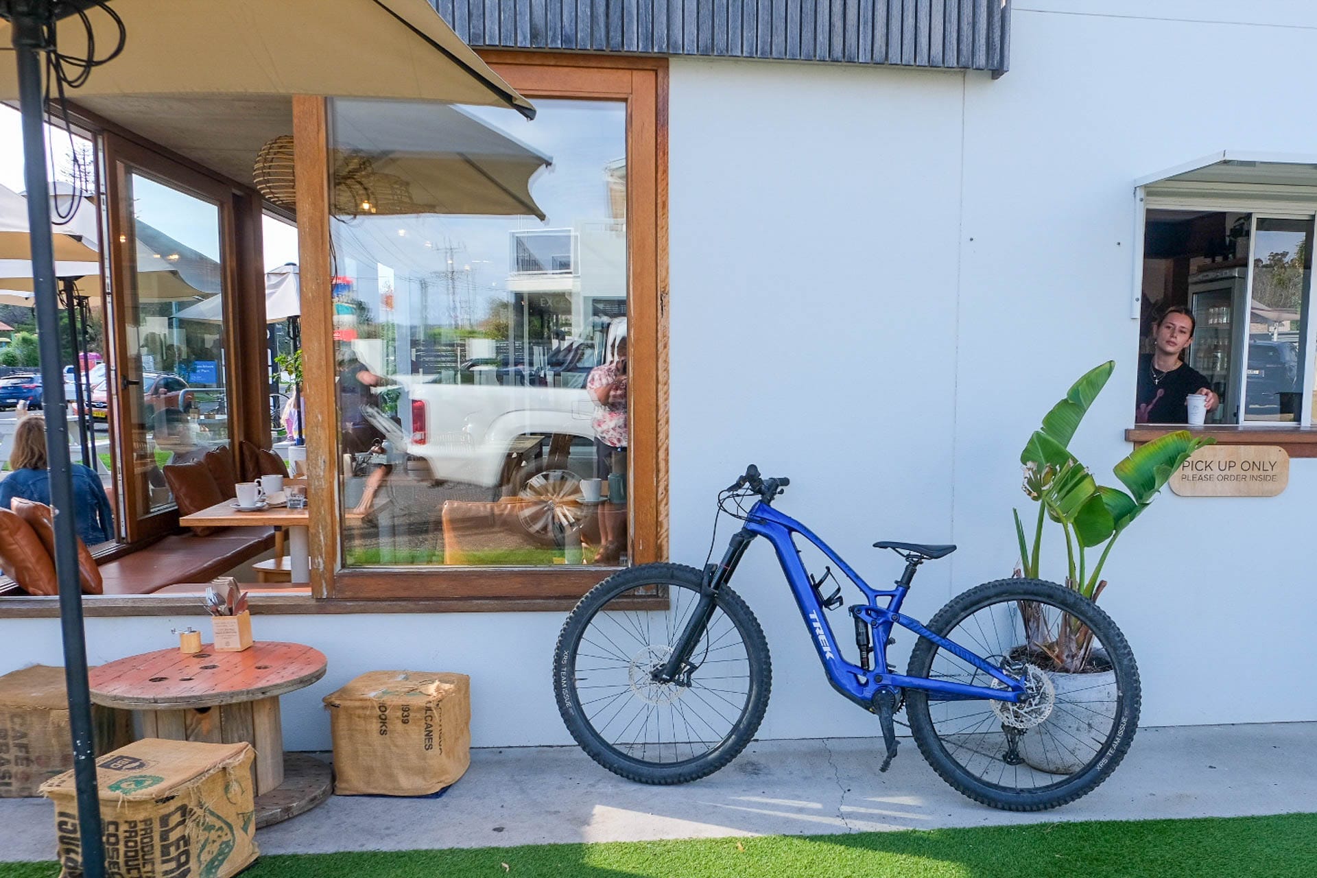 Gravity Eden – Dirt Surfing at NSW South Coast’s Newest Mountain Bike Park, Photo by Sarah Pendergrass, blue bike out front of wild orchid cafe