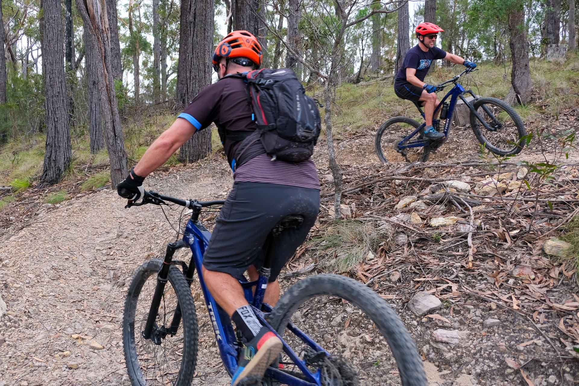 Gravity Eden – Dirt Surfing at NSW South Coast’s Newest Mountain Bike Park, Photo by Sarah Pendergrass, cycling, mountain biking, gravel biking, two mountain bikers going up a hill