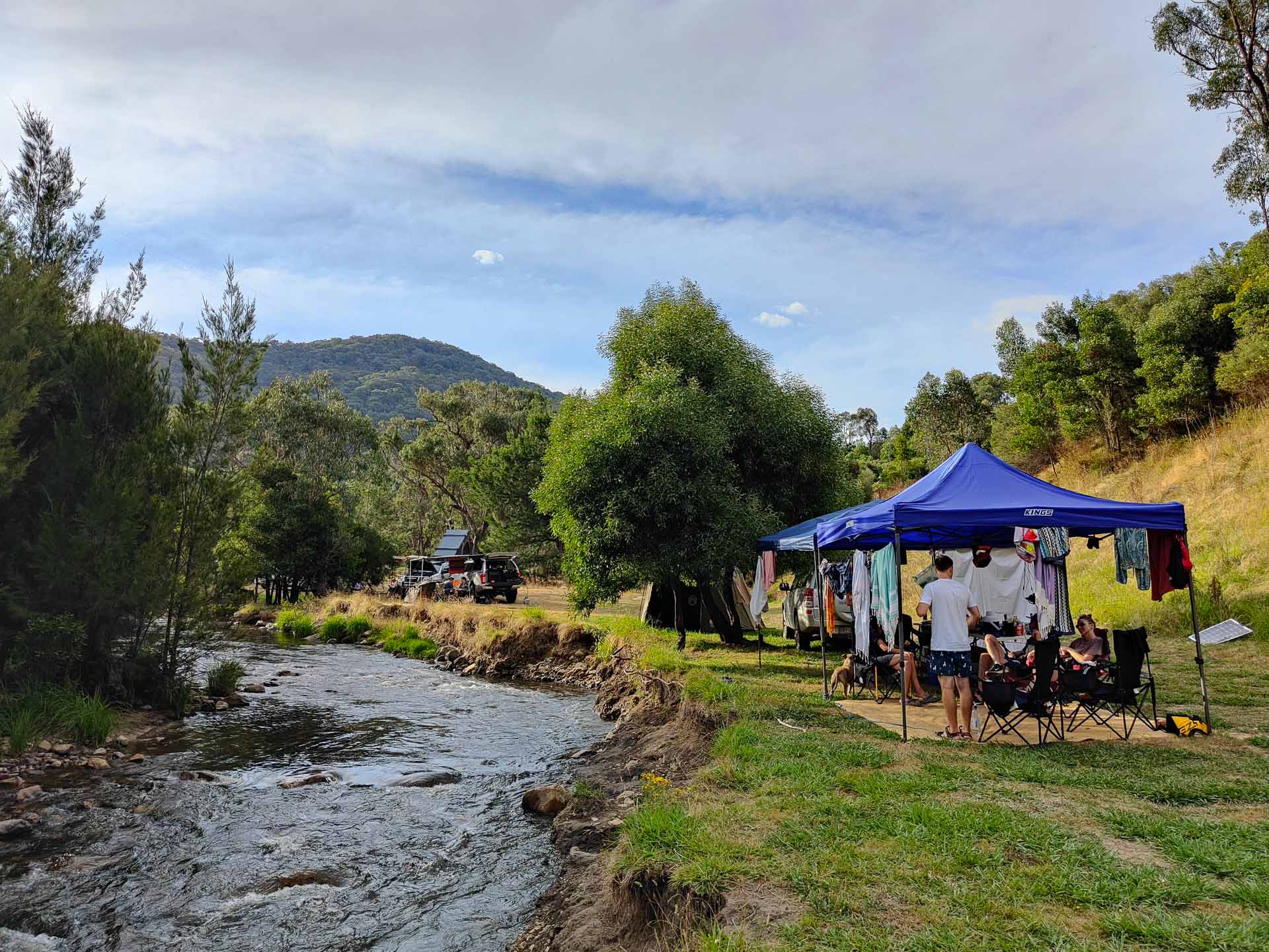 How to Convince Your Friends to Go Camping With You, Photo by Kate Reynolds, camping, gazebo, hanging clothes, rug, campsite, river