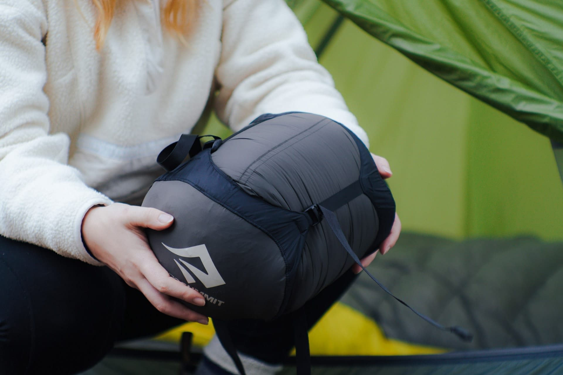 How to Choose a Sleeping Bag, Photo by @aebimedia, Sea to Summit, sponsored, Julia holding a sea to summit sleeping back in its cover