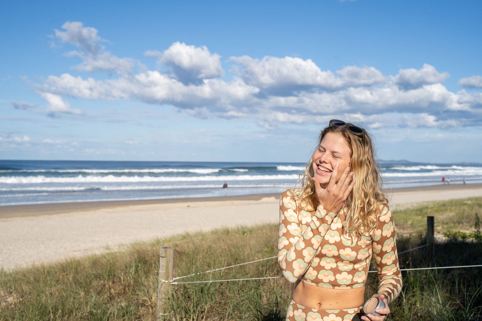 Surf Tripping the New South Wales North Coast, Photo by Isobel Owers, surfing, road trip, itinerary, brunswick heads, north head nature reserve, woman applying sunscreen to her face at the beach