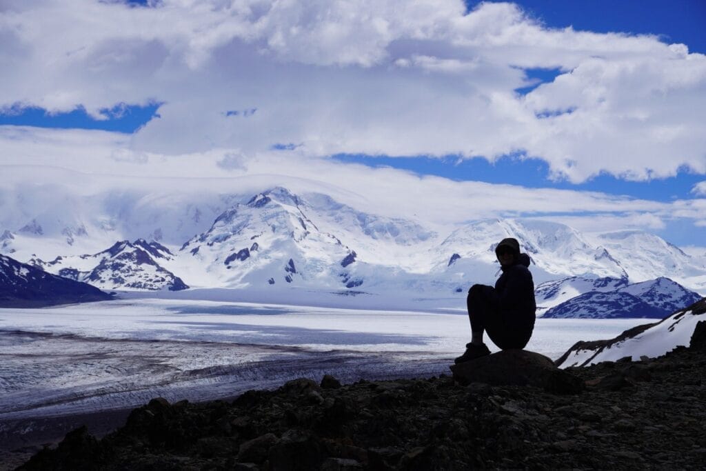 Huemul Trek, Southern Patagonia, Argentina, by Hayley, person sitting, glacier, snow-capped mountains, vast landscape, remote wilderness, El Chaltén