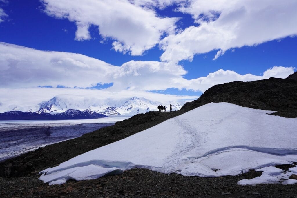 Huemul Trek, Southern Patagonia, Los Glaciares National Park, Argentina, by Hayley, hikers, mountain range, snow, glacier, ice field, blue sky, clouds, rugged landscape, trekking, adventure