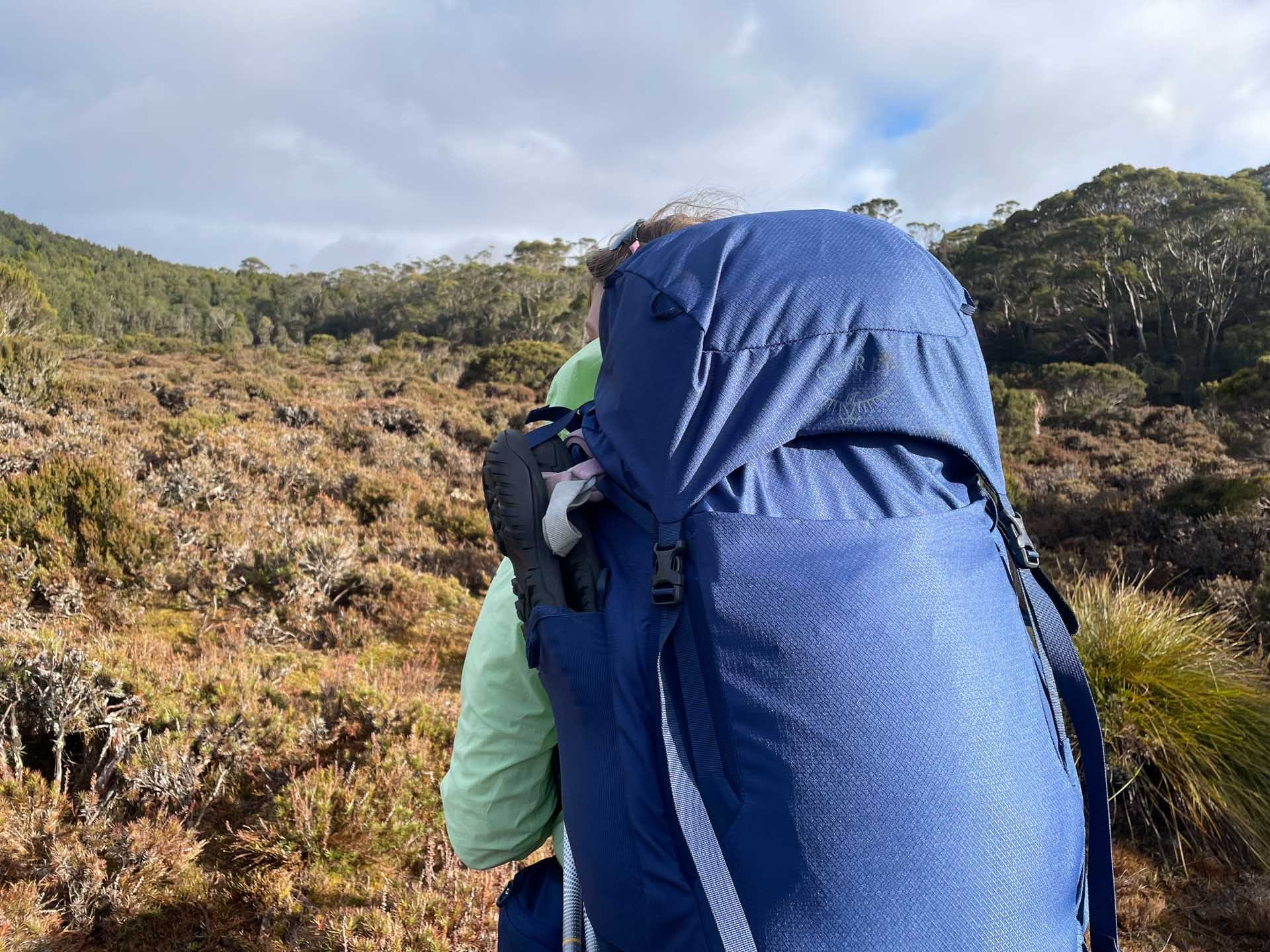 Osprey Kyte 65 Hiking Pack, Overland Track Tasmania, multi-day adventure, hiker, blue backpack, wilderness landscape, outdoor gear