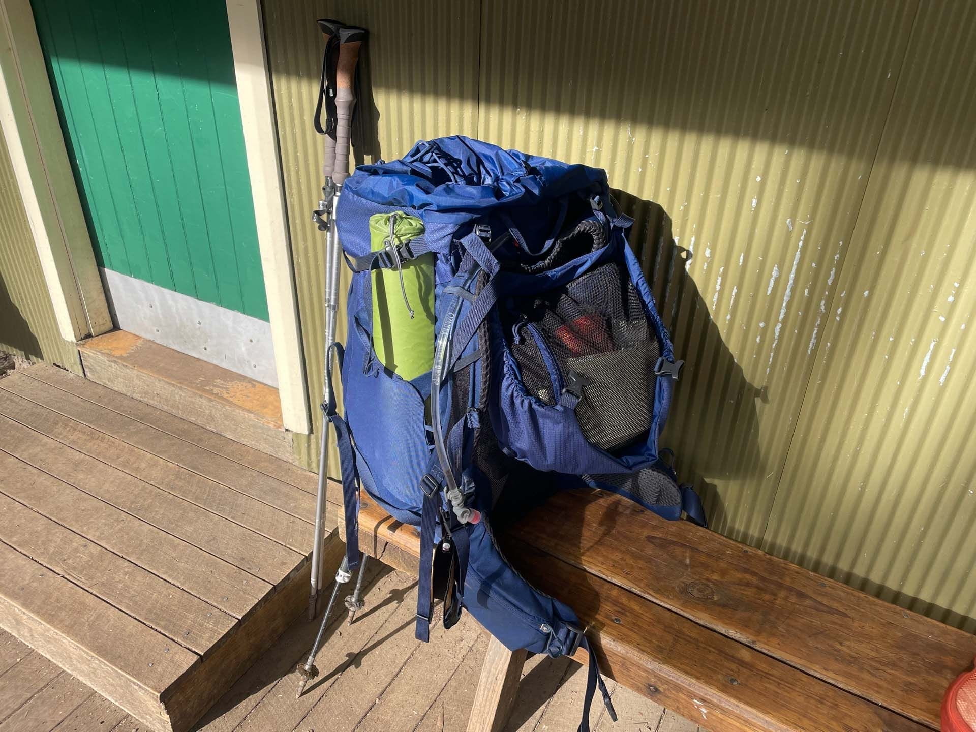 Osprey Kyte 65 Hiking Pack, blue backpack, trekking poles, outdoor gear, multi-day hike, trail equipment, Overland Track