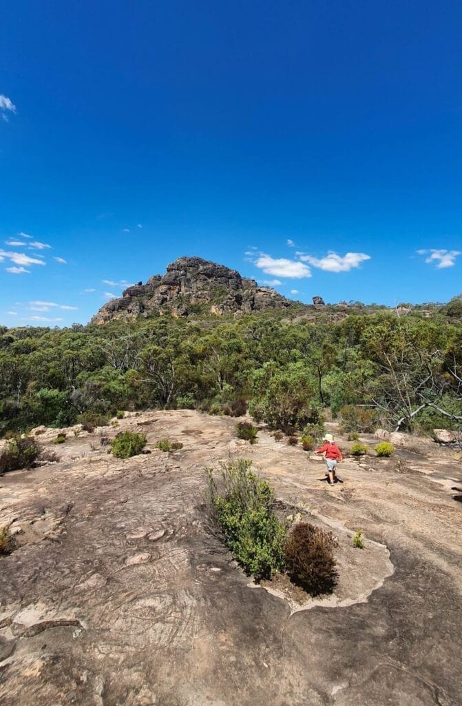 Hollow Mountain Grampians National Park, child hiking, rocky landscape, Australian bushland, blue sky, adventure with kids, listening to Country, by Josh