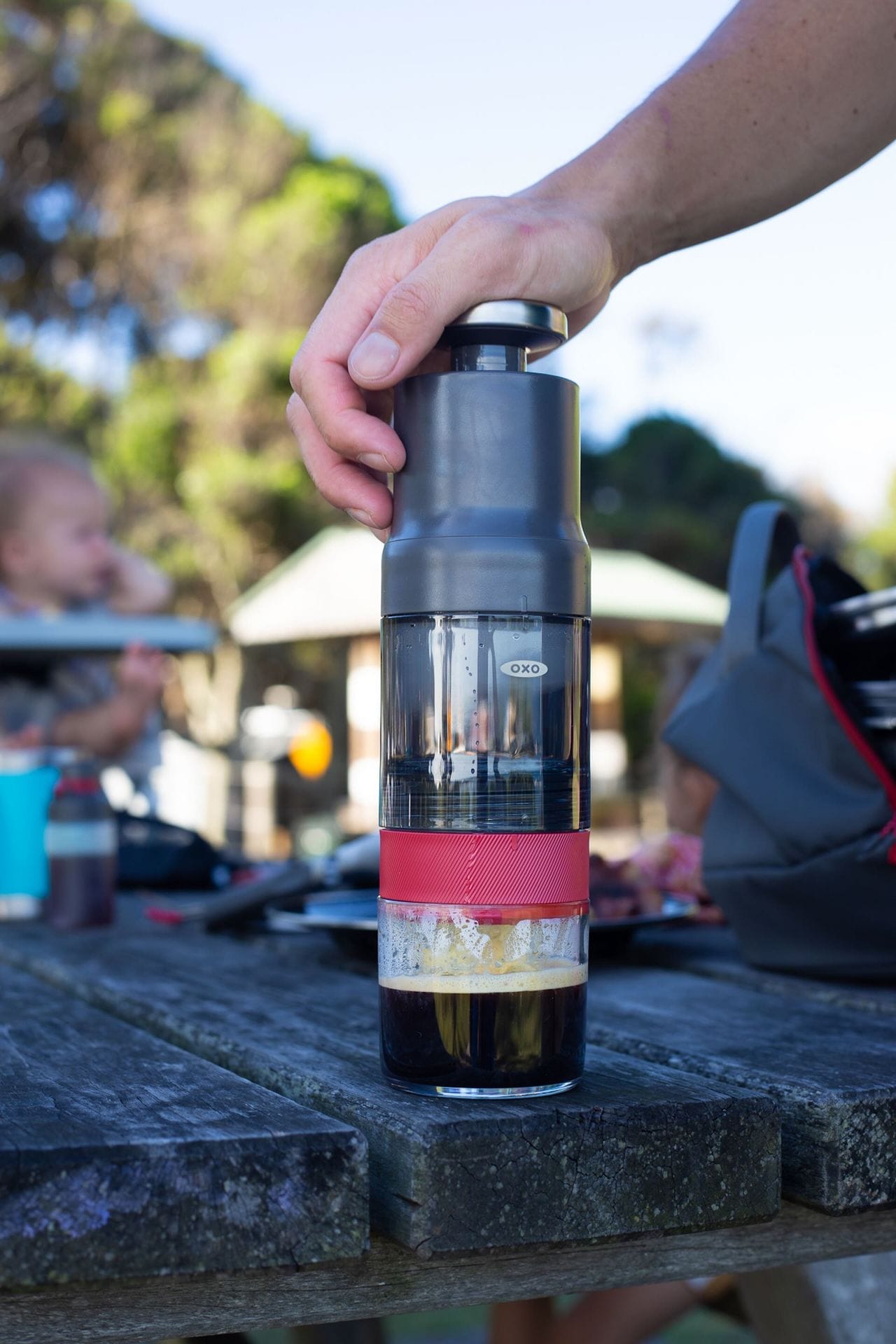 OXO Rapid Brewer, brewing coffee, with crema, wooden table, outdoor setting, camping, camp kitchen equipment
