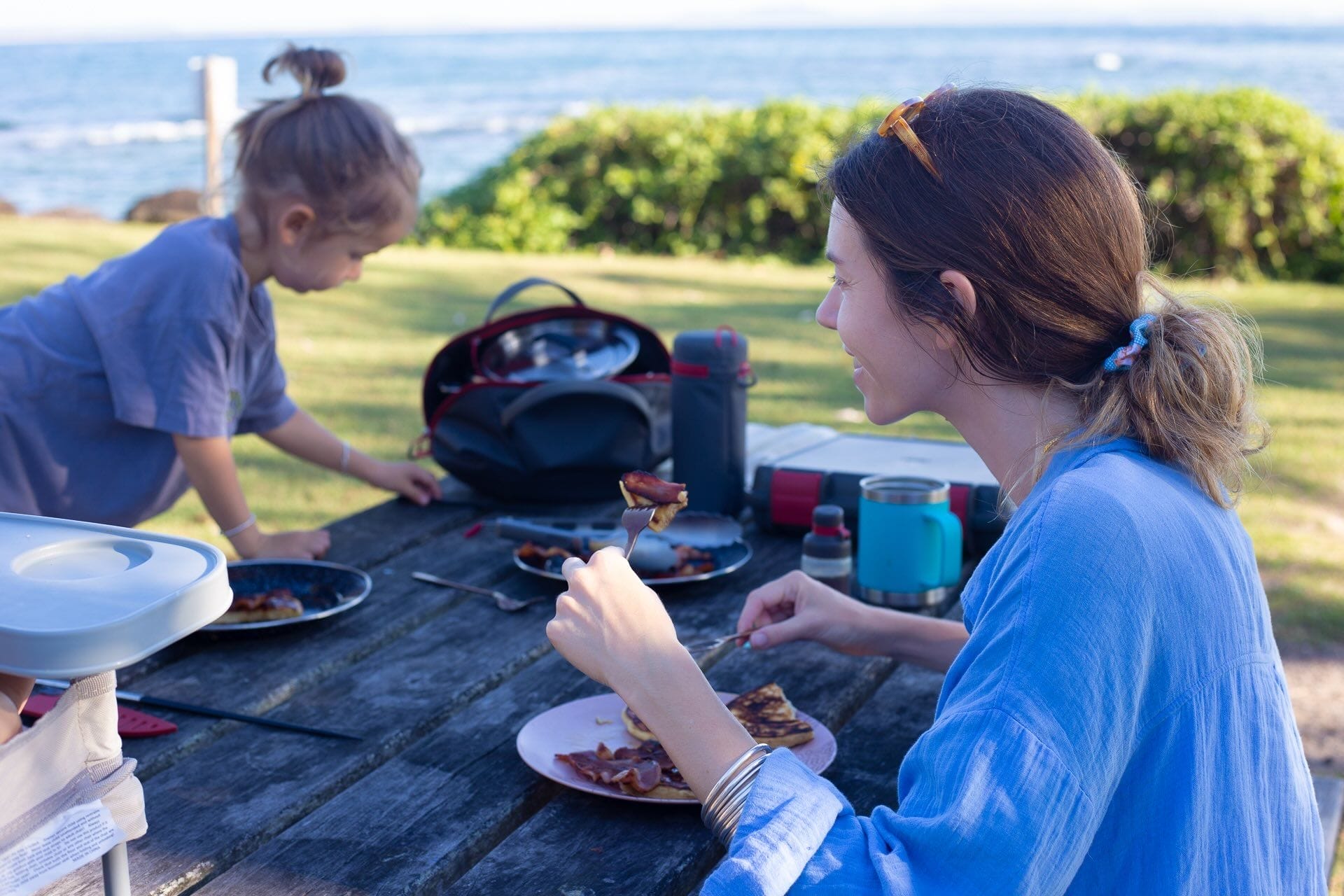 family camping breakfast, outdoor dining, pancakes, bacon, ocean view, picnic table, mother and child, OXO camp kitchen equipment