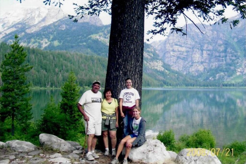 Family Portrait, Mountain Lake, National Park, by Unknown Photographer, Hiking, Outdoor Adventure, Group Photo, Summer, Forest, Mountains, Lake Reflection, Rocky Shore