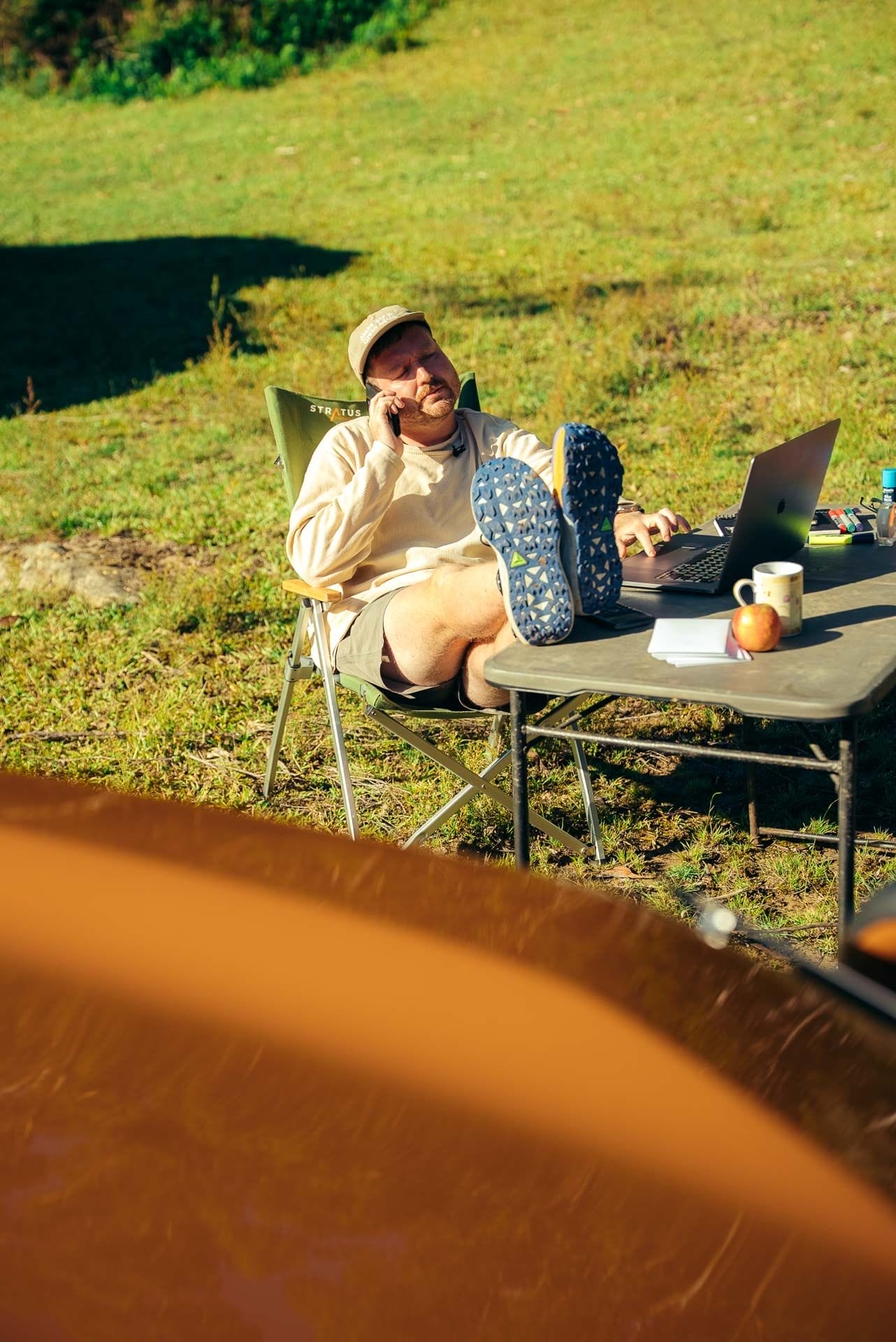 Tim, We Are Explorers, by Paul, remote work, outdoor office, laptop, phone call, camping chair, portable table, sunny, digital nomad, Toyota shoot