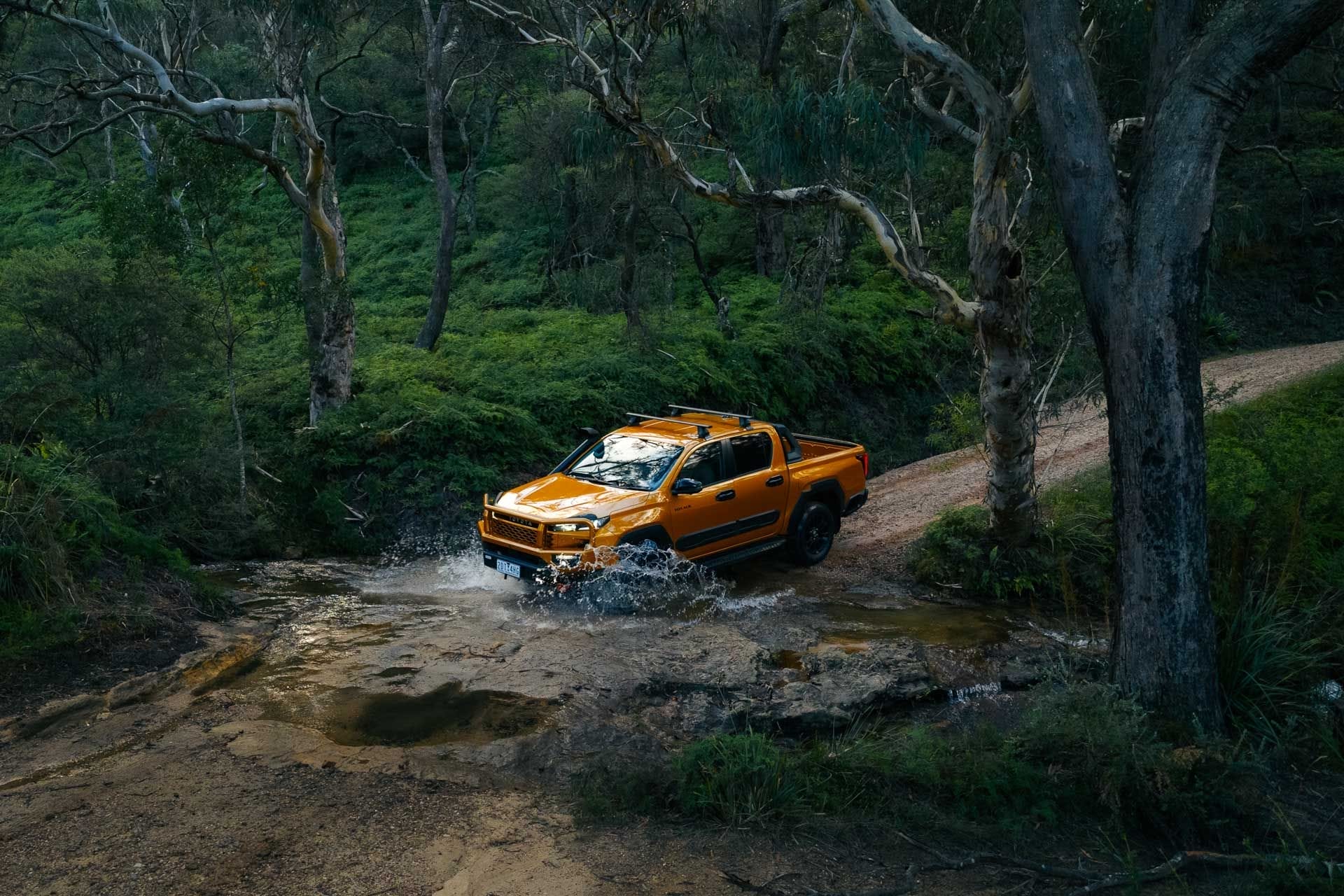 Toyota HiLux, by Daygin, orange pickup truck, driving through water, muddy track, forest, off-road adventure, sunglow