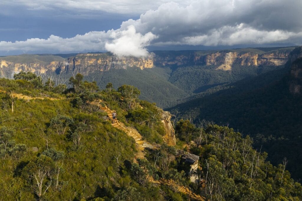 Blue Mountains, Australia, Govetts Leap, by Daygin, trail running, clifftop path, dramatic valley, clouds, sandstone cliffs, adventure photography