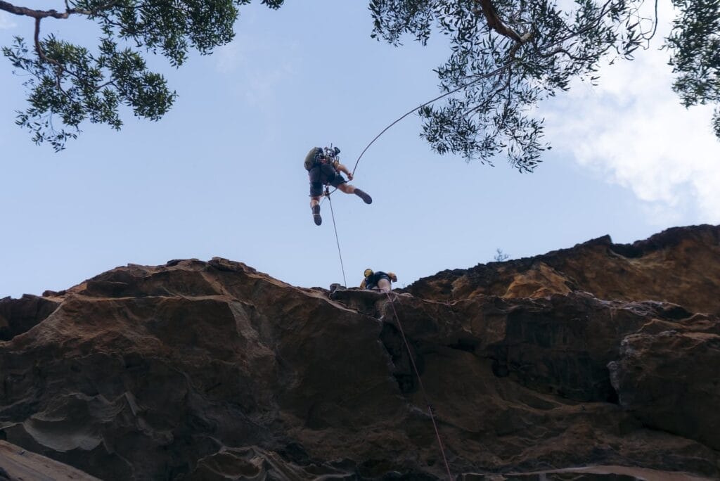 Blue Mountains, Australia, by Daygin, rock climbing, rappelling, outdoor adventure, cliff, clear sky, eucalyptus trees, adventure photography