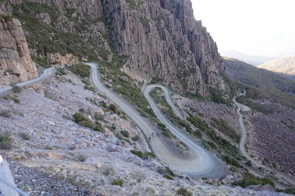 Jacob's Ladder, Ben Lomond, by Rohan Hunt, switchbacks, gravel road, mountain, granite cliffs, cyclists, Tassie Traverse, bikepacking, Tasmania